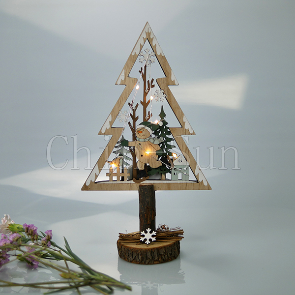 Wooden christmas tree model with LED light on table 